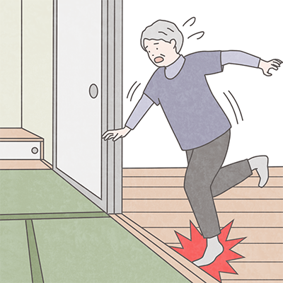 段差でつまづく女性